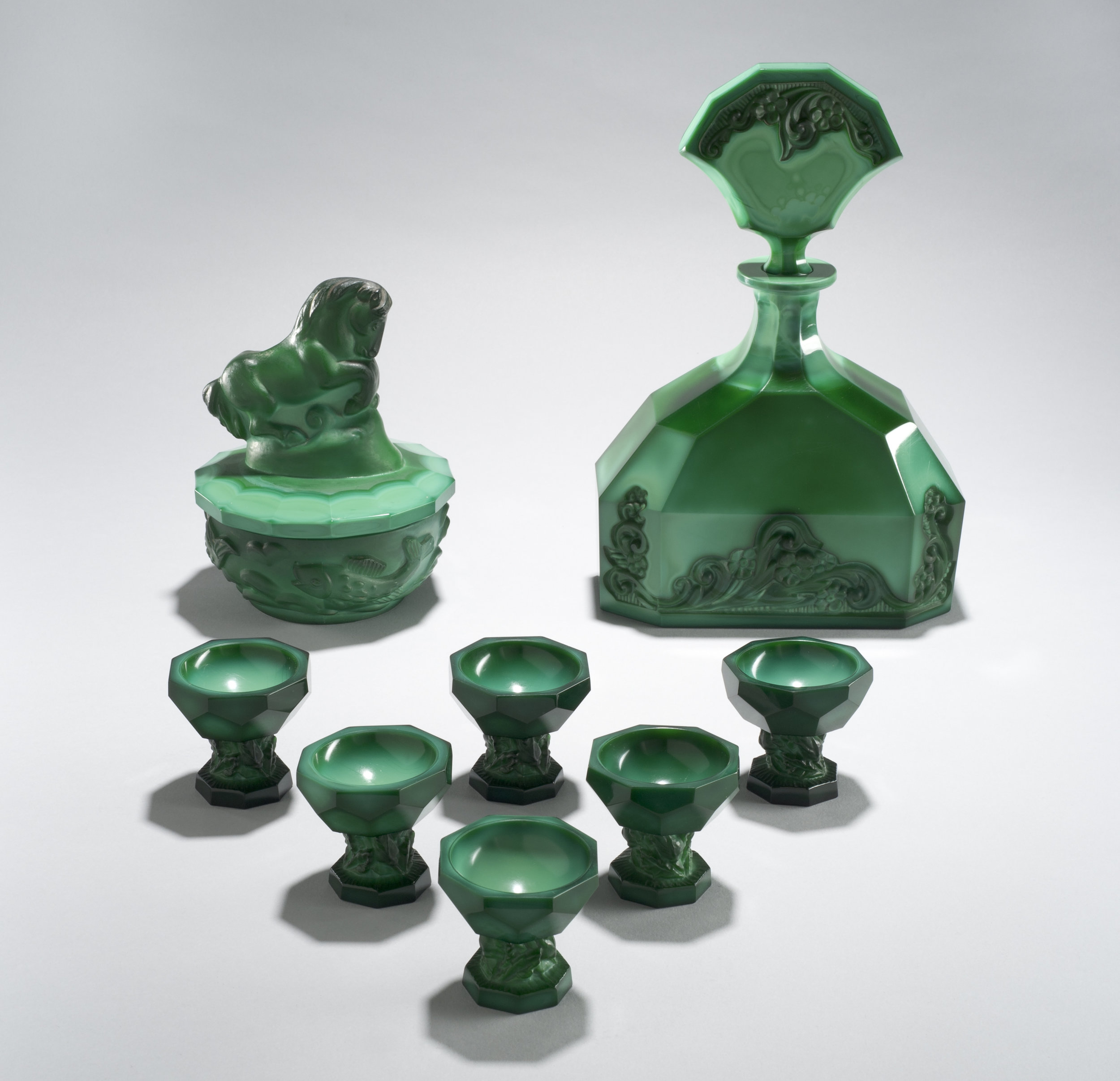  Possibly František Halama (Czech, 1913-1976).&nbsp; Horse Handle Powder box  and  Lisquor Set,  circa 1939.&nbsp;Malachite glass, pressed, matte-cut, and polished;&nbsp;11 1/4 x 7 1/2 x 4 in. Collection of Museum of Glass, Tacoma, Washington, from t